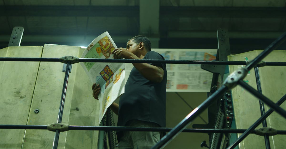 Engineer measuring 3D printed part with digital calipers during first-article inspection