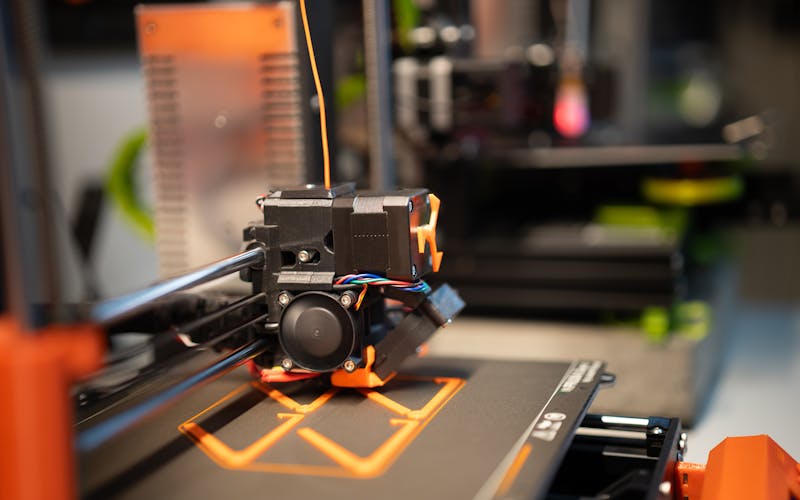 Detail view of a 3D printer extruder at work