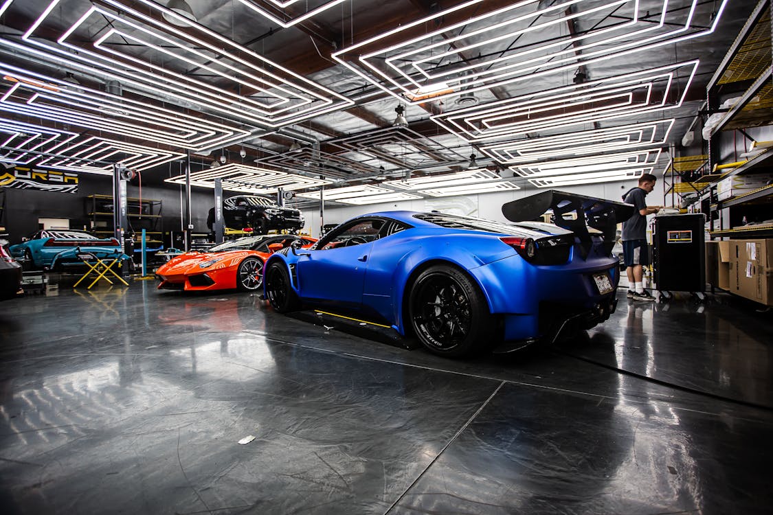 Sports cars being serviced in a high-performance automotive workshop