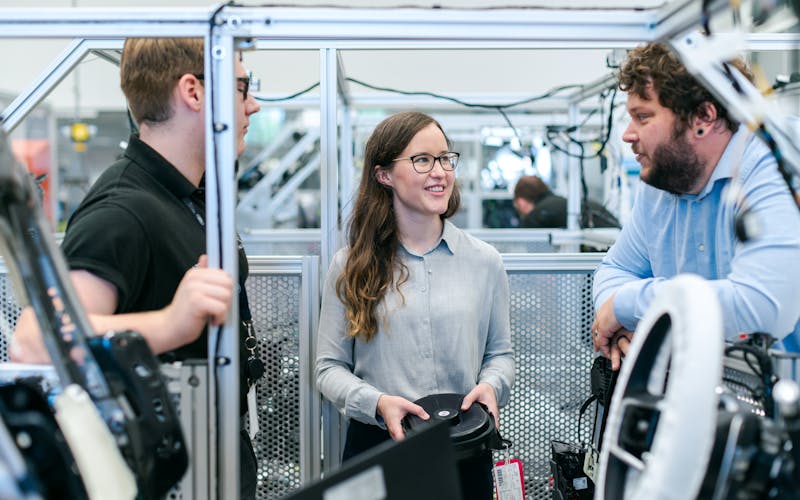 Engineers reviewing industrial parts in a workshop